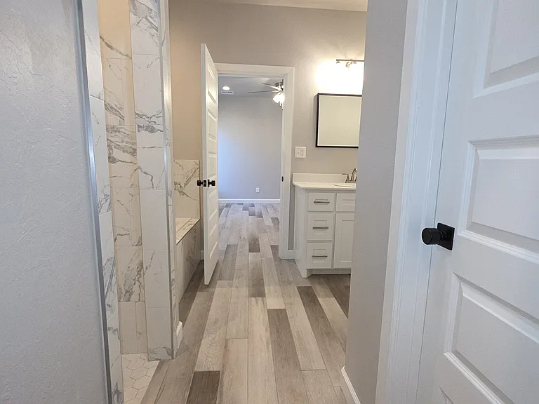 The large Master/Primary bath contains a large walk-in closet on the right, marble shower on the left, water closet behind us.