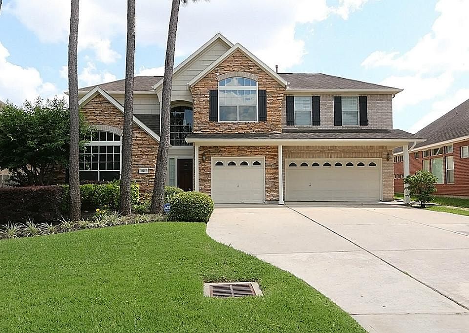 Gorgeous front view, stone and brick, 3-car garage.