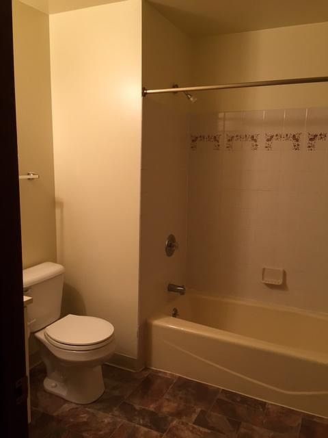 Full bathroom with large storage closet behind door.