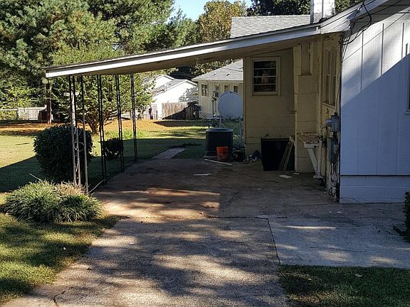 Second driveway on side of house with attached carport