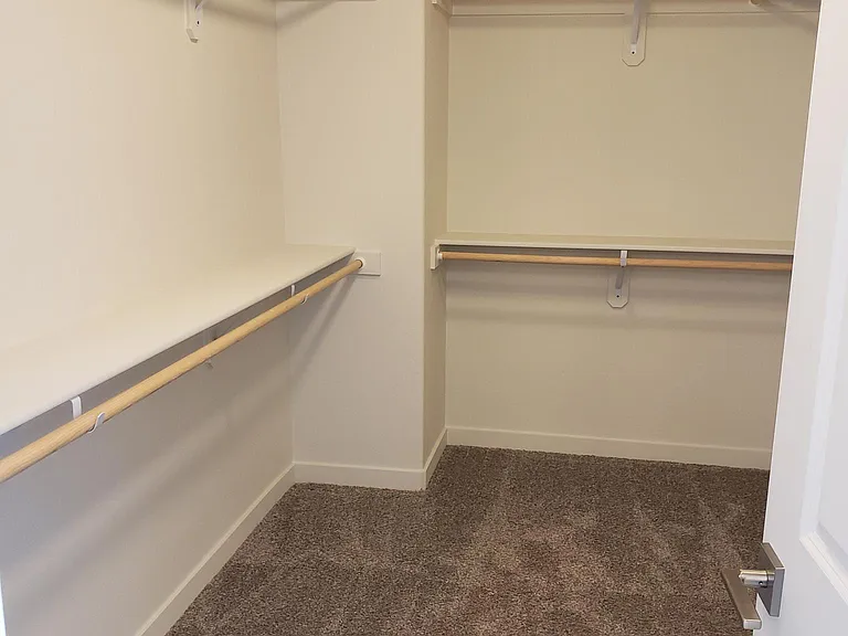 Primary bedroom walk in closet