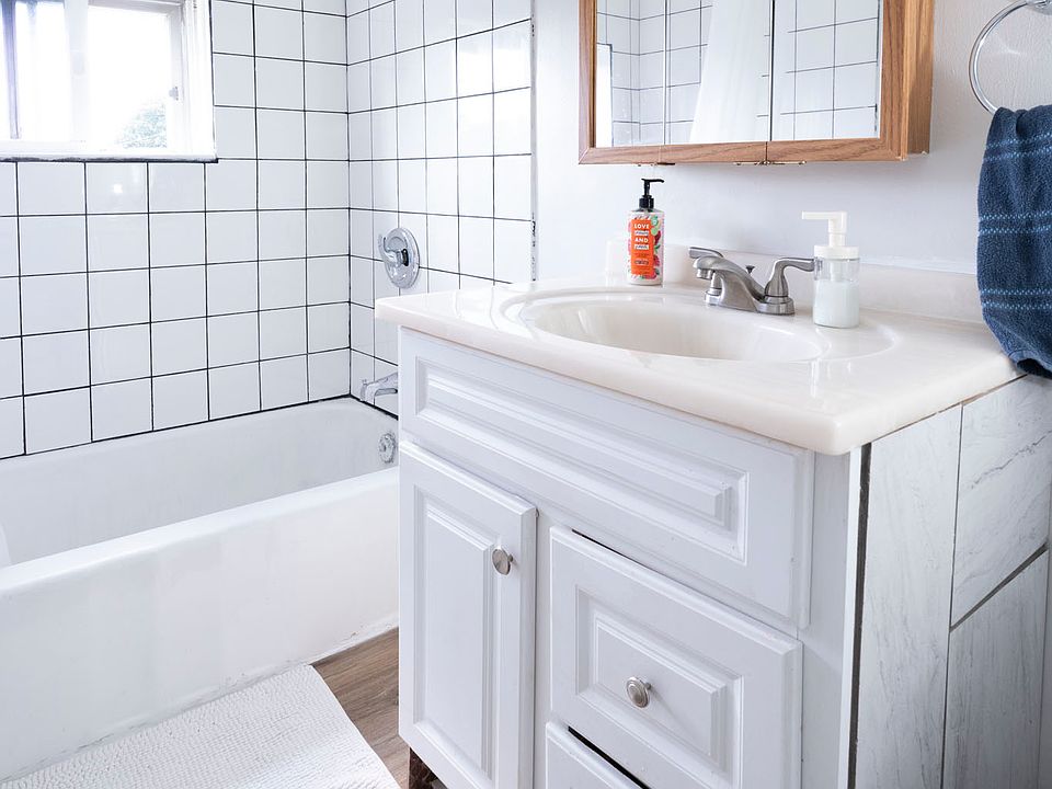 Updated bathroom with new LVP flooring, American Standard toilet, shower tile, and Mohen faucet