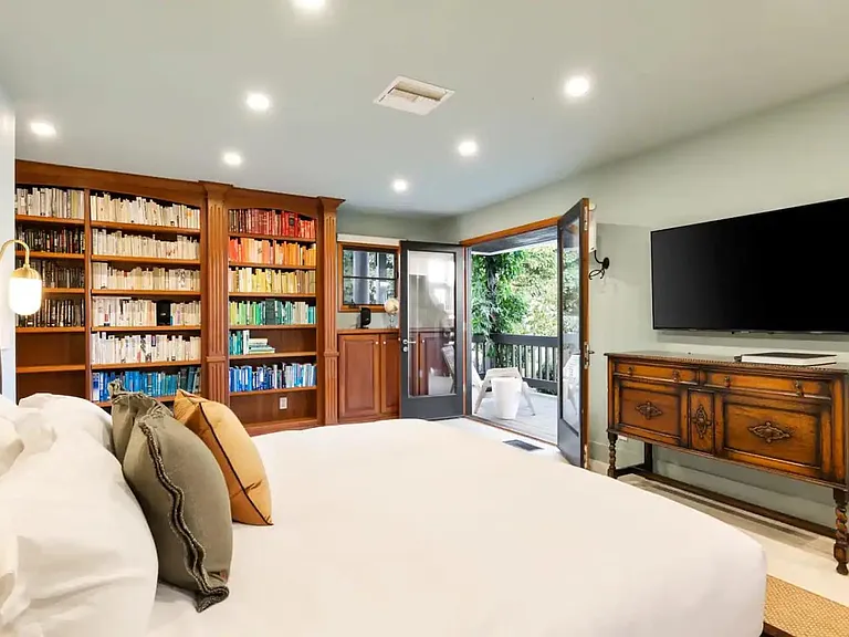 Wind down in Guest Bedroom 1, featuring beautiful wooden touches and unique furniture