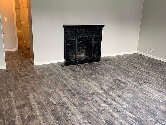 WOOD BURNING FIRE PLACE WITH STOUT SCREEN, TOOLS, AND GRATE. BLACK MARBLE TILE HEARTH. BEAUTIFUL FINISH TRIM WORK, CASEMENT AND FLOOR TRIM.