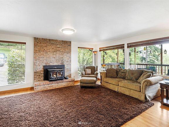 Large living room with wood fireplace.