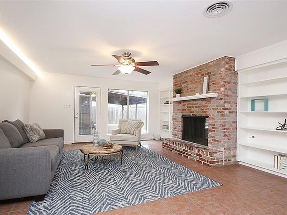 The family room is huge and shares the other side of the fireplace in this open floor plan. Built-ins on both sides and a door to your outdoor deck in back.