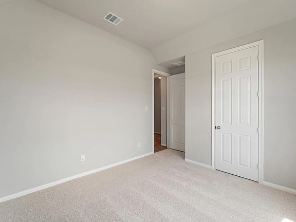 An additional view of the second bedroom and closet.