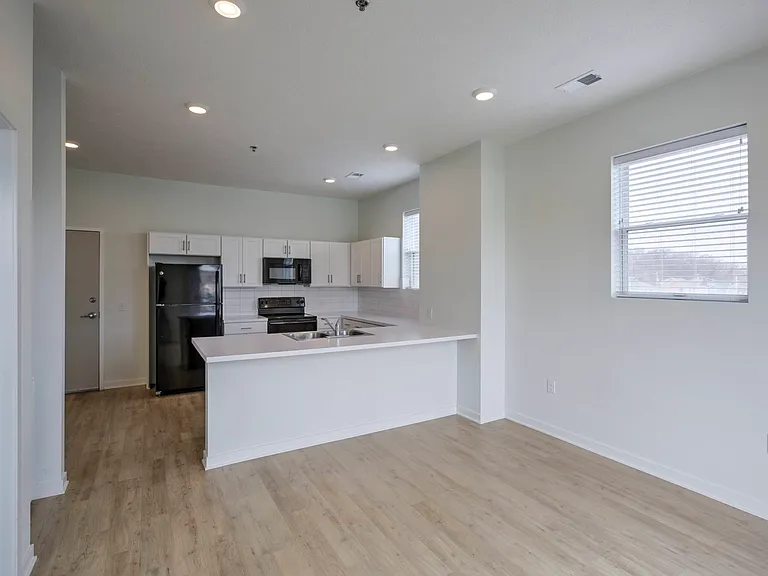 Living room and kitchen in a unit at The Rise.