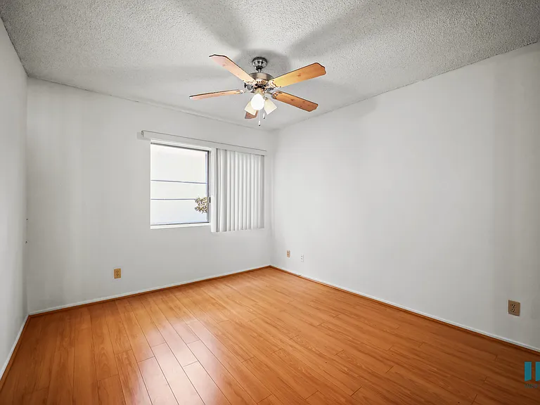 Bedroom with a Ceiling Fan and Vinyl Flooring