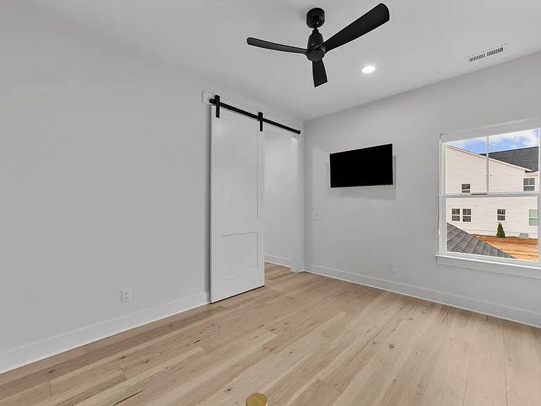 Barn door leading to another flex space off the bonus