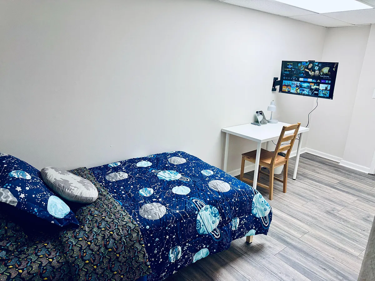 Furnished bedroom with twin bed, desk and chair, and wall-mounted TVideal for studying and relaxing after work. - Wyntercreek Dr