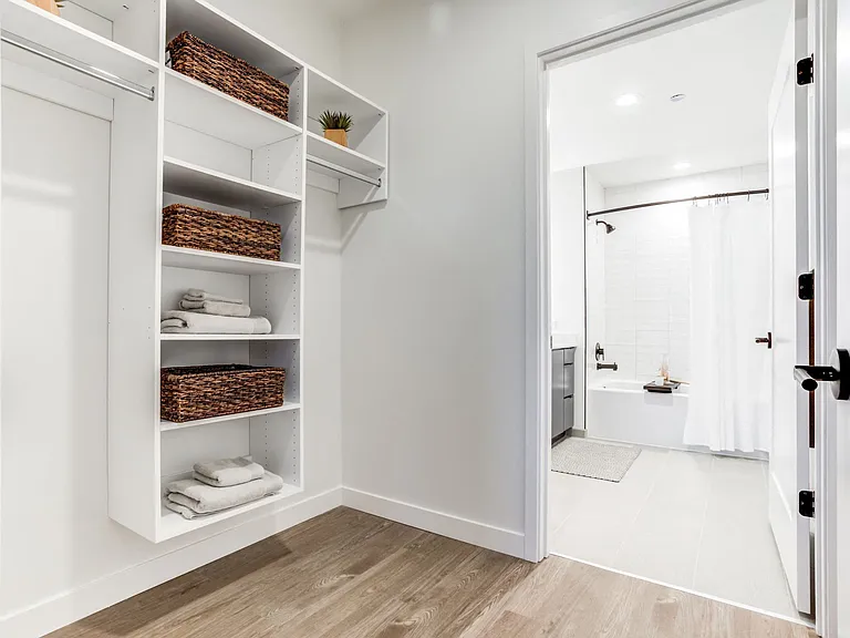 Enjoy the convenience of a closet that seamlessly leads into the bathroom, offering easy access and efficient use of space.