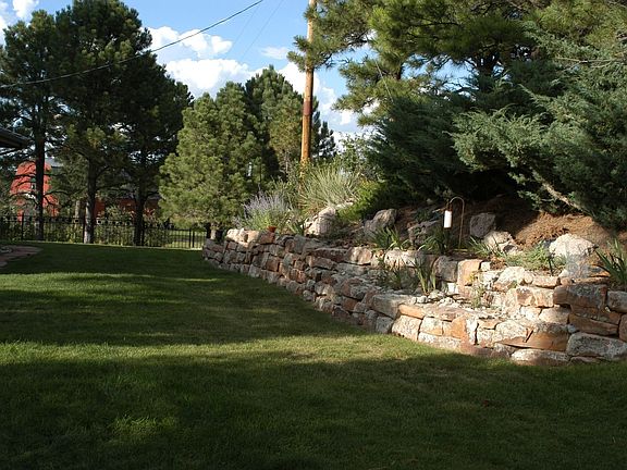 Our backyard with custom iron fencing