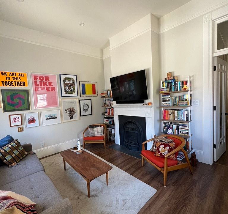 Living room w/ gas fireplace, recessed lighting, tall ceilings, door with transom window