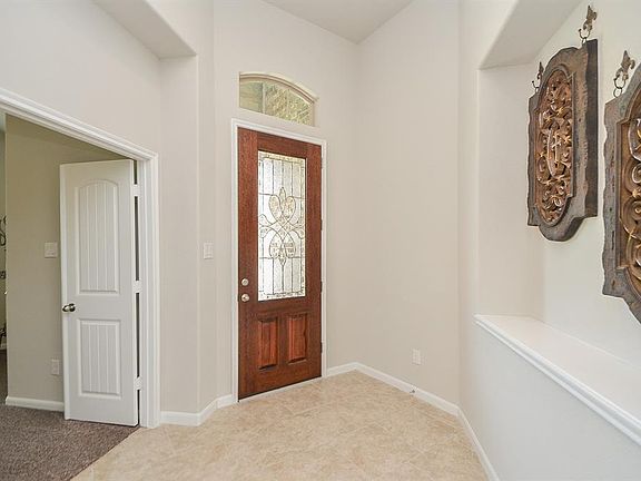 The sunlight floods into this beautiful entry! With a gorgeous glass door and arched transomâyouâll be proud to welcome your guests into this cheerful foyer.