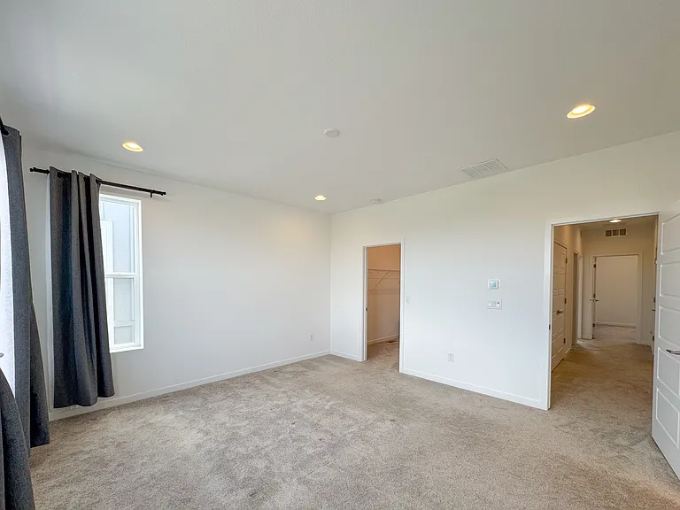 Warm, comfortable master bedroom with plenty of natural light