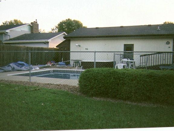 Summer pictures of the pool and perfectly manicured lawn.