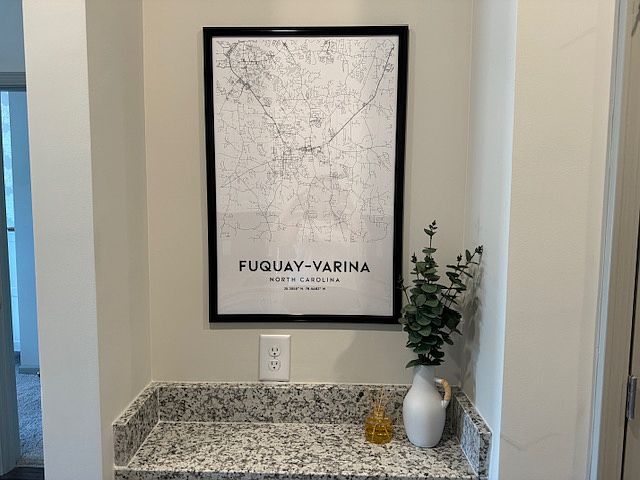 Small ledge opposite the kitchen cabinets. Perfect for a phone and computer charging station.