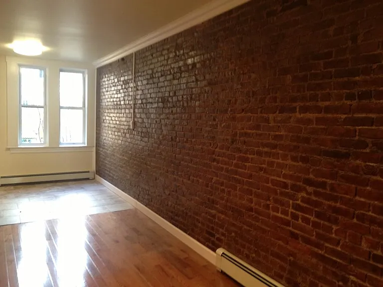 Expsed brick in living room and kit