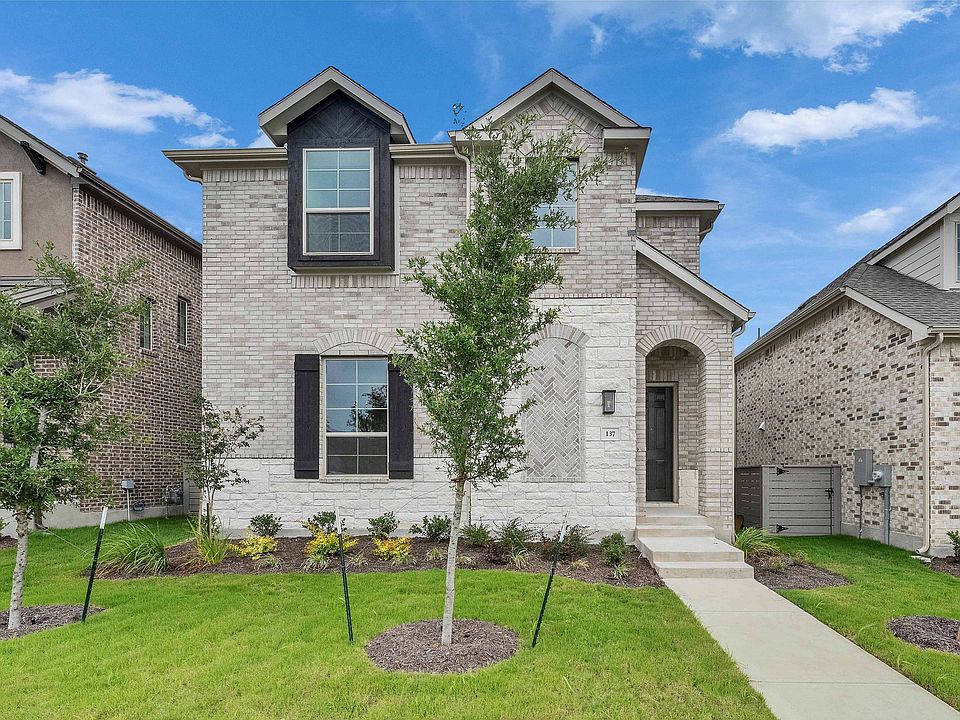 Experience luxury in Flora with this two-story home featuring a sophisticated gray brick exterior an