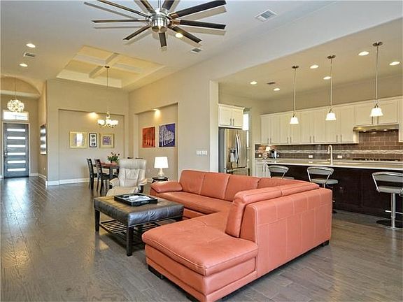 Here is another look at the family room which shows that the formal dining room and the kitchen are all open to each other.  Lovely art niches and a detailed beamed ceiling are included in the formal dining room.