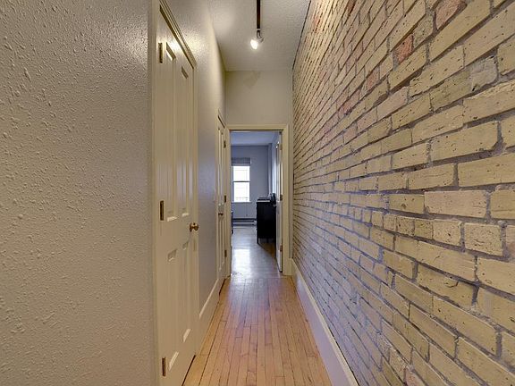 Hallway leading from entrance to bedroom (first door on the left is a closet, second door on the left is the bathroom)