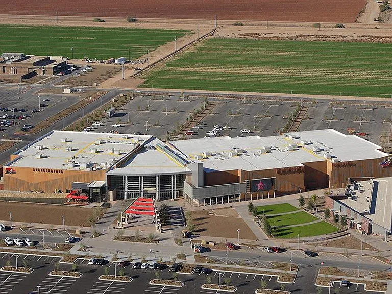 Aerial view of a large commercial building with extensive parking lots and landscaped entry areas.