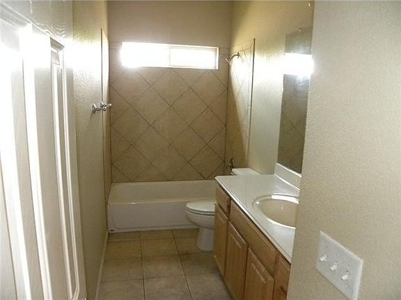 Two full bathrooms with tubs and showers upstairs. Half bath downstairs.