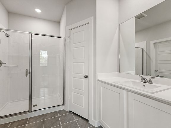 Primary Bathroom in the Cedar home plan by Trophy Signature Homes - REPRESENTATIVE PHOTO