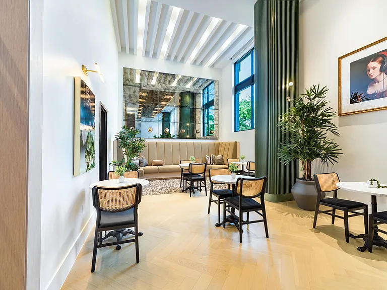 Community seating lounge with cafe tables, banquettes, and natural light offering a relaxed place to gather near Nashville's growing neighborhoods.
