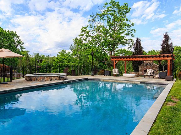 Fully Enclosed Pool with Safety Cover Large Spa and Outdoor Fireplace.