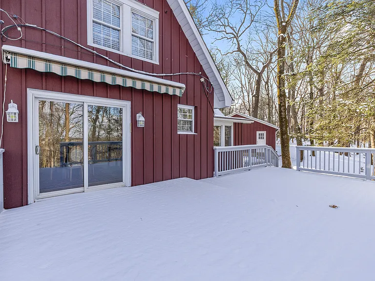 Sliding glass door from large rear deck with awning