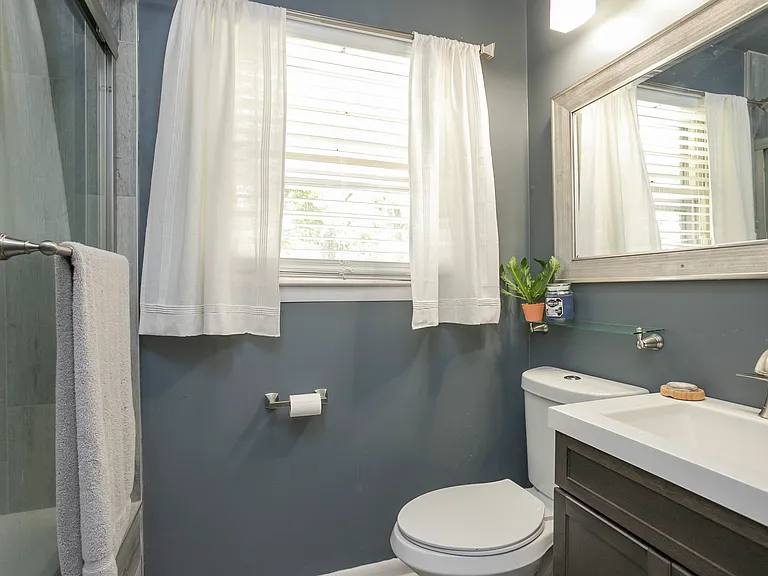 Fully gutted and renovated in both bathrooms. This is the first bathroom with shower/tub combo with sliding glass door.