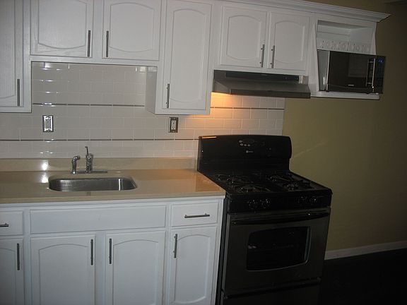 Marble Counter Undermount Sink and Stainless Appliances