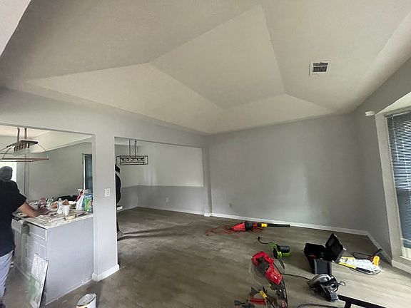 The open kitchen and dining radiate warmth and togetherness, featuring a family room centered around an island ideal for gatherings and culinary adventures. The seamless flow between the spaces enhances their charm, making it perfect for entertaining.