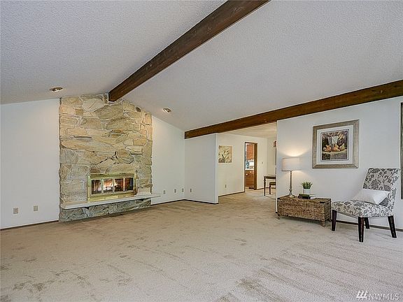 Formal living room with a beautiful floor to ceiling fireplace.