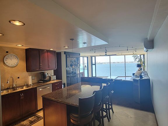 kitchen and living room with air conditioning and heat (as well as each bedroom), a fireplace, and big screen tv above it