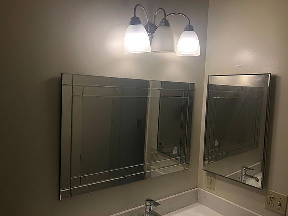 New bathroom mirrors, lighting, vanity and faucets.