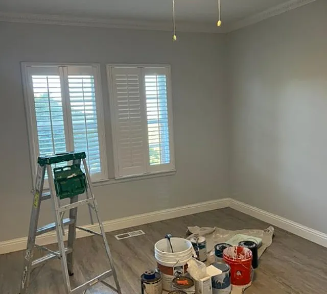 Bedroom 2, As you can see painters are at work. Shutters on windows. Overhead light fan combination. Closet not shown.