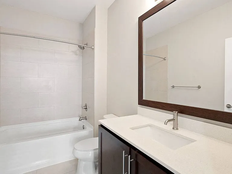 Bright bathrooms with large mirrors.