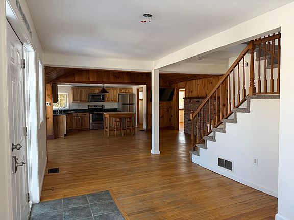 This is the view of the first floor, living area, dining area, and kitchen from the front door.