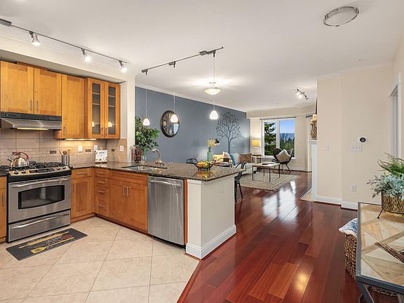 Modern kitchen with granite countertops, stainless steel appliances - large refrigerator, microwave, gas oven/cooktop and dishwasher. Nine foot ceilings throughout condo