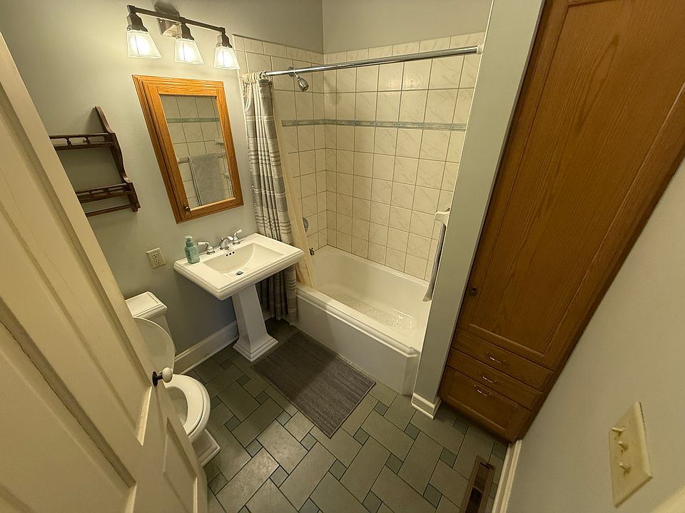 Bathroom with shower over tub, vanity, and toilet