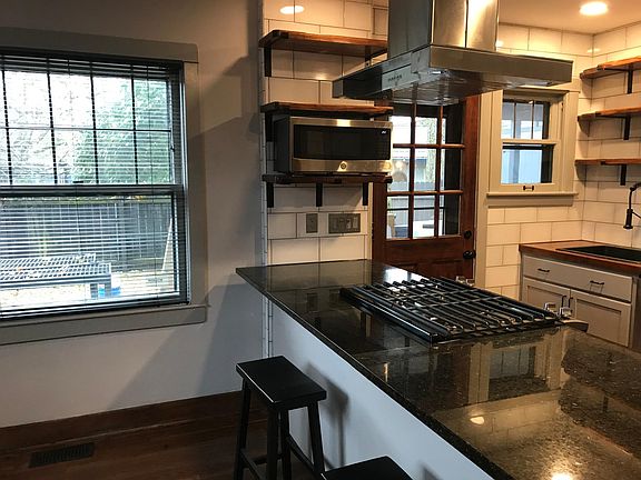 Island hood over gas range.