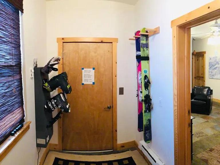 Gear storage room with 12-slot gear dryer and hanging ski storage (we've since added a little bench for getting ready)