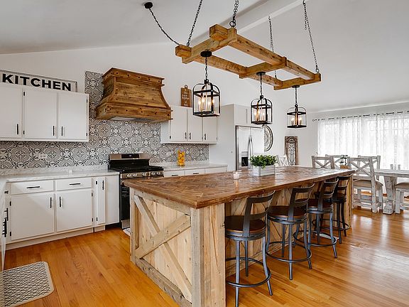 Continuous hardwood flooring throughout the kitchen/dining area give the space a cohesive look.