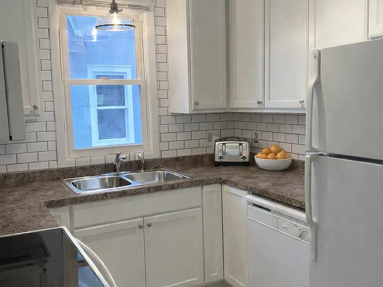 Fresh and clean kitchen. New counters, cabinets, sink, lighting and tile floor.