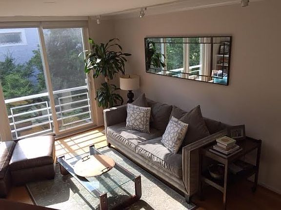 Living room with fireplace and built in bookshelves (not shown on opposite wall).