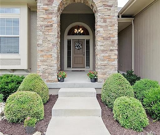 Beautiful stacked-stone entry way and covered porch.  Yard includes sprinkler system and lawn/landscape is professionally maintained.