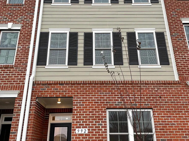 Partial Brick front with small yard and plenty of windows for natural light